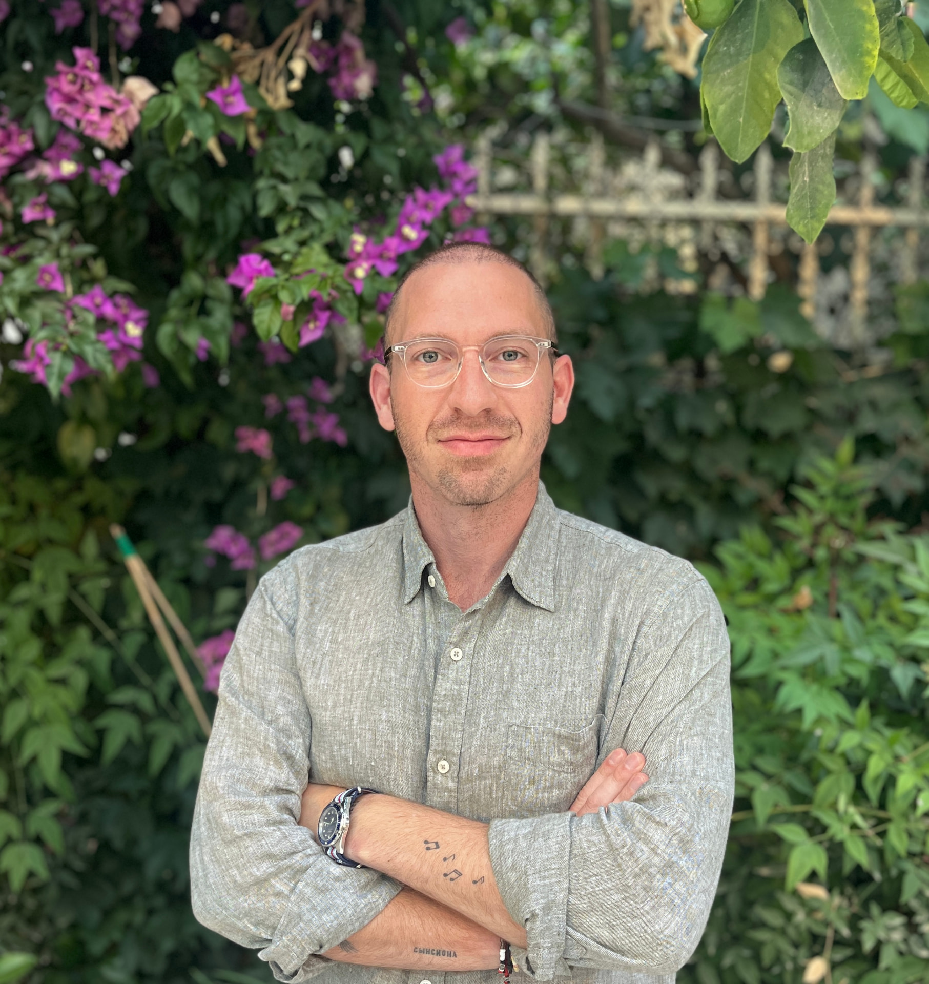 Bentzy, men's coach, standing outdoors with arms crossed
